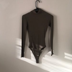 Green turtleneck body suit